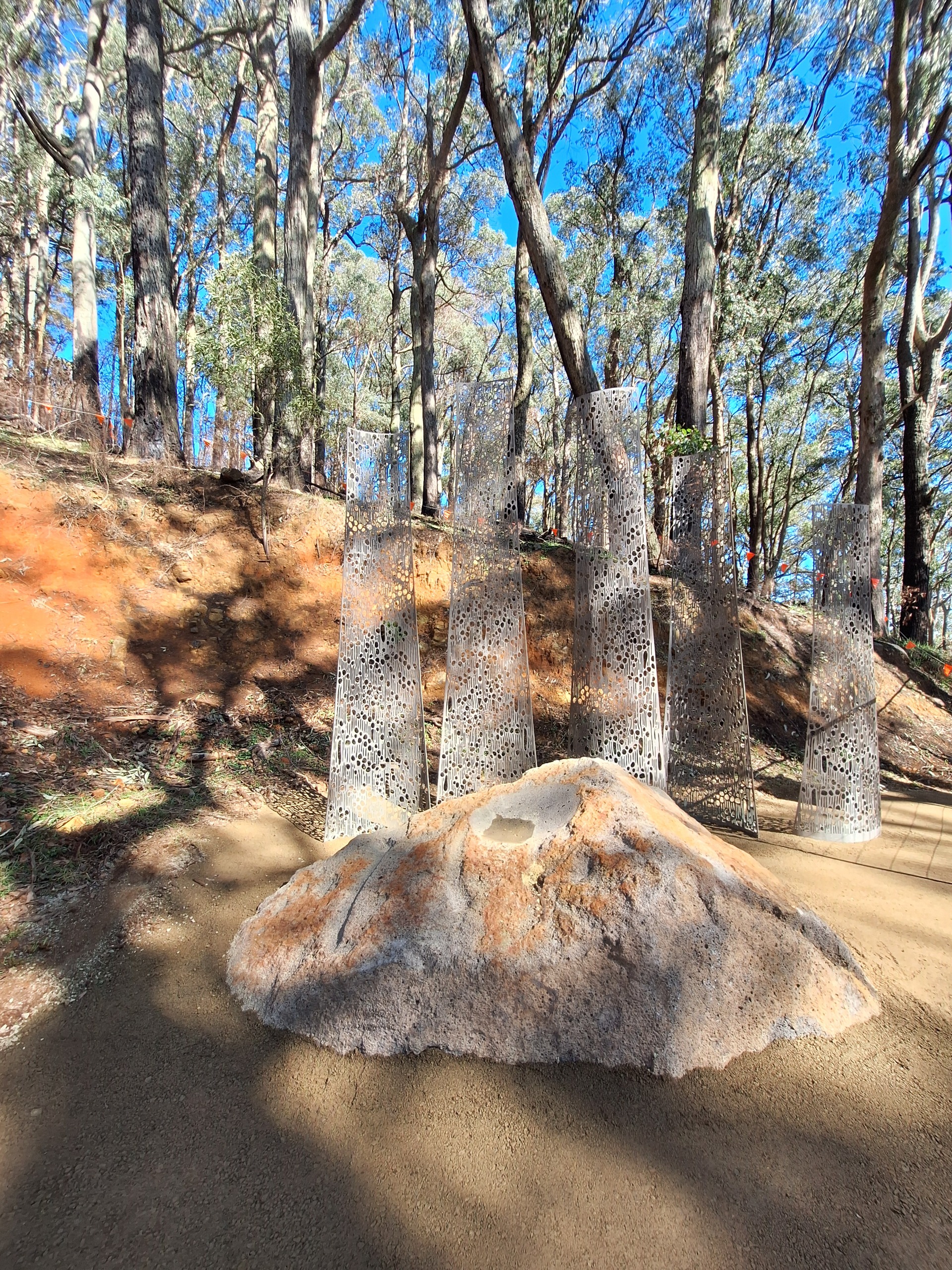 steel and boulder sculpture in the bush