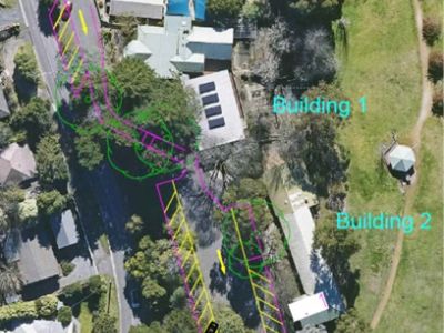 Aerial view of site, showing buildings and carparks.